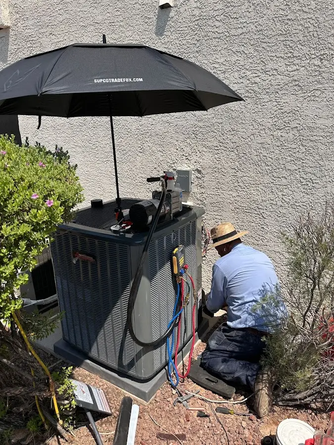 HVAC technician performing outdoor AC maintenance in Lehi
